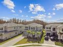 Aerial view of a neighborhood with several houses, showcasing a modern home's design at 32176 Rosewood Meadow Ln, Wesley Chapel, FL 33543