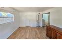 Bright living room boasts wood-look floors, fresh paint, and great natural light from a large window at 527 4Th Nw Ave, Largo, FL 33770