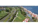 An aerial view of the property with a golf course, highway, and waterway in the background at 5825 Puerta Del Sol S Blvd # 170, St Petersburg, FL 33715