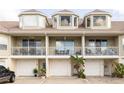A charming townhouse featuring individual balconies and garages, enhanced by decorative plants and meticulous landscaping at 8246 Aquila St, Port Richey, FL 34668