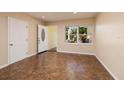 Bright entryway with tile flooring, open door to hallway, and window looking out to yard at 6614 10Th Avenue S Ter, St Petersburg, FL 33707