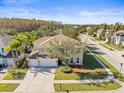 Aerial view of a two-story house with a three-car garage and driveway at 17800 Souter Ln, Land O Lakes, FL 34638
