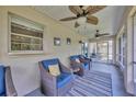 Relaxing screened-in porch features a ceiling fan, comfortable seating, and views of the backyard at 2104 Hembury Pl # 33, Sun City Center, FL 33573