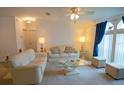 Bright living room featuring comfortable seating and large windows at 37449 Gill Ave, Zephyrhills, FL 33541
