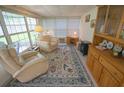 Relaxing sunroom with comfortable seating and built-in shelving at 37449 Gill Ave, Zephyrhills, FL 33541