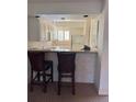 Efficient galley kitchen features granite countertops and breakfast bar at 4774 Fox Hunt Dr # C115 &C113, Wesley Chapel, FL 33543