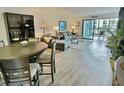 Spacious living area with hardwood floors and access to a balcony at 855 Bayway Blvd # 207, Clearwater Beach, FL 33767