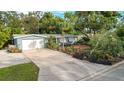 House with driveway and landscaped yard, aerial view at 351 Barbara Cir, Belleair, FL 33756