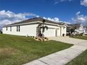 Home exterior showcasing the side and garage at 1027 Ocean Spray Dr, Ruskin, FL 33570
