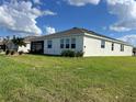 Rear exterior view, showcasing covered patio at 1027 Ocean Spray Dr, Ruskin, FL 33570