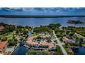 Aerial view of waterfront community with a canal and pool at 2571 Cyprus Dr # 1-202, Palm Harbor, FL 34684