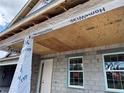 Close up of the front porch showing the white front door and unfinished ceiling at 417 Shannon Estates Ct, Plant City, FL 33563