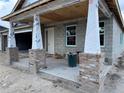 View of the front porch with brick support columns on a home under construction at 417 Shannon Estates Ct, Plant City, FL 33563