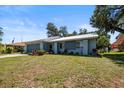 A cozy one-story home with tidy landscaping, an attached garage, and a fresh coat of paint at 1467 Monte St, Port Charlotte, FL 33952