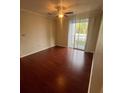 Bedroom with hardwood floors and sliding door to balcony at 18001 Richmond Place Dr # 425, Tampa, FL 33647