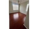 Bedroom with hardwood floors and large window at 18001 Richmond Place Dr # 425, Tampa, FL 33647