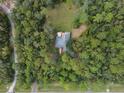 Breathtaking bird's-eye view of home surrounded by dense trees with a serene wooded lot at 5143 Culbreath Rd, Brooksville, FL 34601