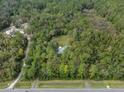 Stunning aerial view of a secluded home nestled within a lush green forest offering privacy at 5143 Culbreath Rd, Brooksville, FL 34601
