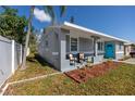 Newly renovated home with gray exterior and turquoise door at 5721 12Th S Ave, Gulfport, FL 33707