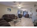 Bright living room with leather furniture and tiled floors at 1623 Dartmouth Dr, Holiday, FL 34691