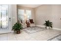 Bright and spacious entryway with tile flooring, natural light, and seating area at 2117 Valterra Vista Way, Valrico, FL 33594