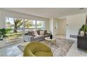 Bright living room featuring a gray sofa, large windows, and stylish decor at 3275 Fox Hill Dr, Clearwater, FL 33761