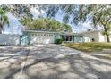 Light blue single story home with a driveway at 3275 Fox Hill Dr, Clearwater, FL 33761