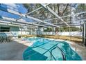 Inviting screened pool area with patio furniture, offering ample space for relaxation and entertainment at 3275 Fox Hill Dr, Clearwater, FL 33761