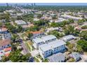 Wide aerial view shows the property in a neighborhood with mature trees and its proximity to local schools and shops at 407 S Albany Ave # 4, Tampa, FL 33606