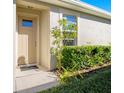 Inviting front door entrance with lush landscaping at 7733 Timberview Loop, Wesley Chapel, FL 33545