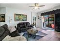 Spacious living room with comfortable seating and tile floors at 7733 Timberview Loop, Wesley Chapel, FL 33545