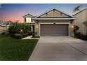 Two-story house with a two-car garage at dusk at 9157 Bella Vita Cir, Land O Lakes, FL 34637