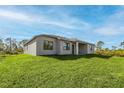 Spacious backyard features a lush green lawn that is perfect for outdoor activities at 12152 Snow Bird Ave, Port Charlotte, FL 33981