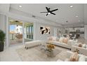 Bright living room with water view, featuring a comfy sofa and access to a balcony at 211 Dolphin Pt # 202, Clearwater Beach, FL 33767