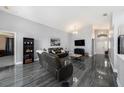 Open concept living room with luxury floors and vaulted ceilings at 35502 Welby Ct, Zephyrhills, FL 33541