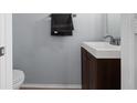 Small half bathroom with dark brown vanity and white sink at 2210 Lake Woodberry Cir, Brandon, FL 33510