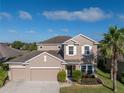 Two-story house situated in a quiet residential neighborhood near a lake at 11339 Tayport Loop, New Port Richey, FL 34654