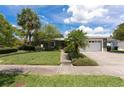 Charming single-story home featuring a two-car garage and a well-manicured lawn with mature landscaping at 1943 Bayou Grande Ne Blvd, St Petersburg, FL 33703