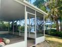 Spacious screened patio with a waterfront view, perfect for outdoor living and enjoying the tropical scenery at 1943 Bayou Grande Ne Blvd, St Petersburg, FL 33703