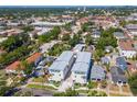 A high-angle view of the property surrounded by a residential neighborhood with mature trees at 407 S Albany Ave # 6, Tampa, FL 33606
