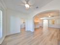 Bright living room with hardwood floors and views into kitchen and backyard at 1148 Emerald Hill Way, Valrico, FL 33594