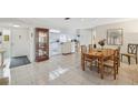 Condo dining room with wooden table and kitchen view at 3942 Trophy Blvd, New Port Richey, FL 34655