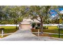 Inviting two-story home with a well-kept lawn, mature trees, and an attached two-car garage at 1605 Acorn Seed Ct, Valrico, FL 33594