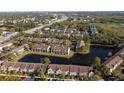 Aerial view of townhome community by a lake at 6212 Bayside Key Dr, Tampa, FL 33615