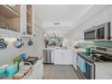 Bright kitchen features stainless steel appliances and white cabinetry at 6372 Palma Del Mar S Blvd # 320, St Petersburg, FL 33715