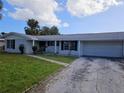 House front view, featuring a brick facade and a large grassy lawn at 4354 50Th S Ter, St Petersburg, FL 33711