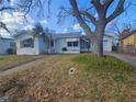 Front view of a single-story house with a yard and palm trees at 469 80Th Way, St Pete Beach, FL 33706