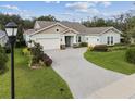 House exterior featuring a two-car garage and landscaped yard at 101 Brookover Ln, Brandon, FL 33511