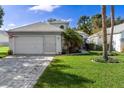 One-story house with attached garage and landscaped yard at 11036 Via De Rosa Ln, Spring Hill, FL 34608