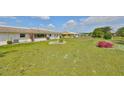 Lush backyard featuring a manicured lawn, perfect for relaxation and outdoor activities at 1529 Allegheny Dr, Sun City Center, FL 33573